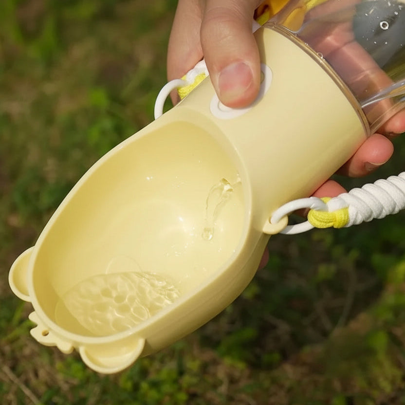 A close-up of a hand holding a beige pet water bowl outdoors on grass, professional remove any overlaid text make it clean and realistic
